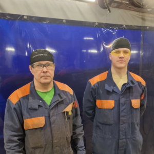 A trainer and a student at the welder training program